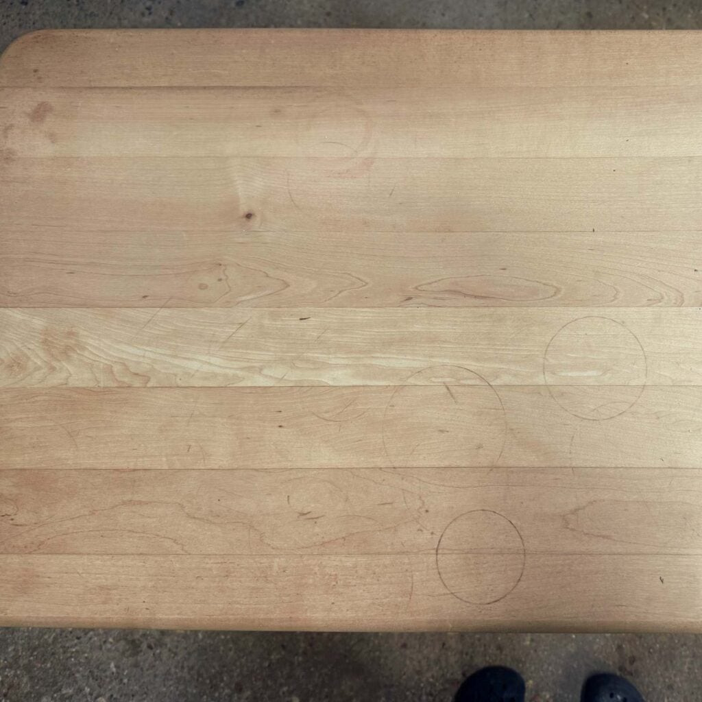close up of butcher block top with stains and water rings.