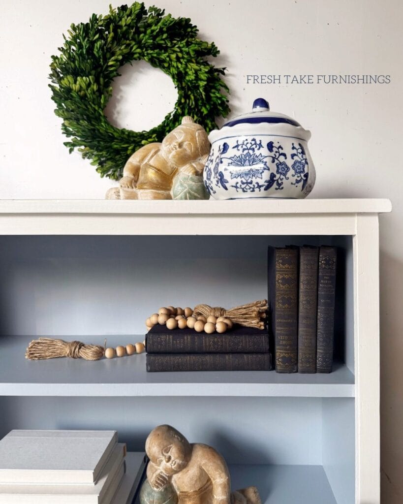 Close up photo of white and blue painted bookcase.