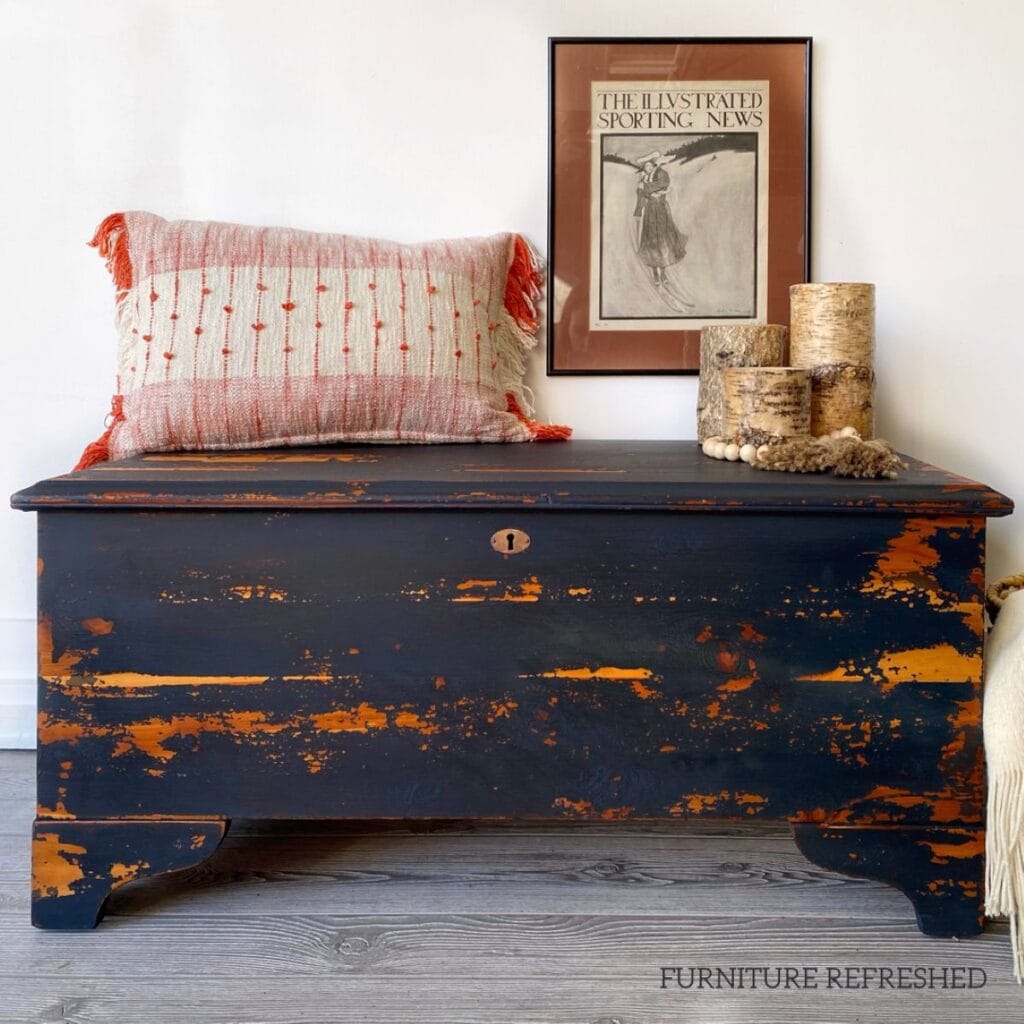 After photo if cedar chest with a dark blue chippy painted finish