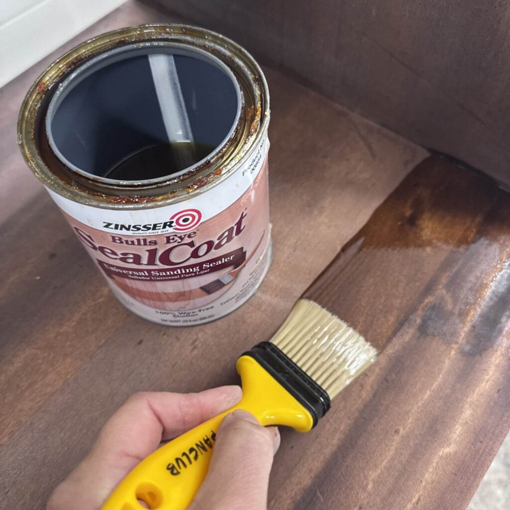 Applying shellac to the stripped wood on this desk.