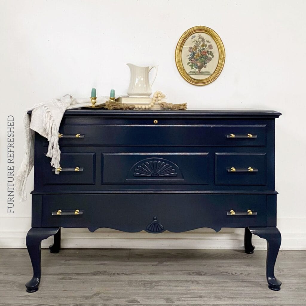 Queen Anne style cedar chest painted in dark navy blue with a gloss finish.