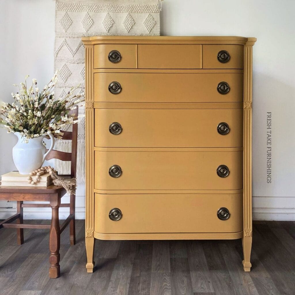 Photo of tallboy hepplewhite style dresser painted golden yellow.