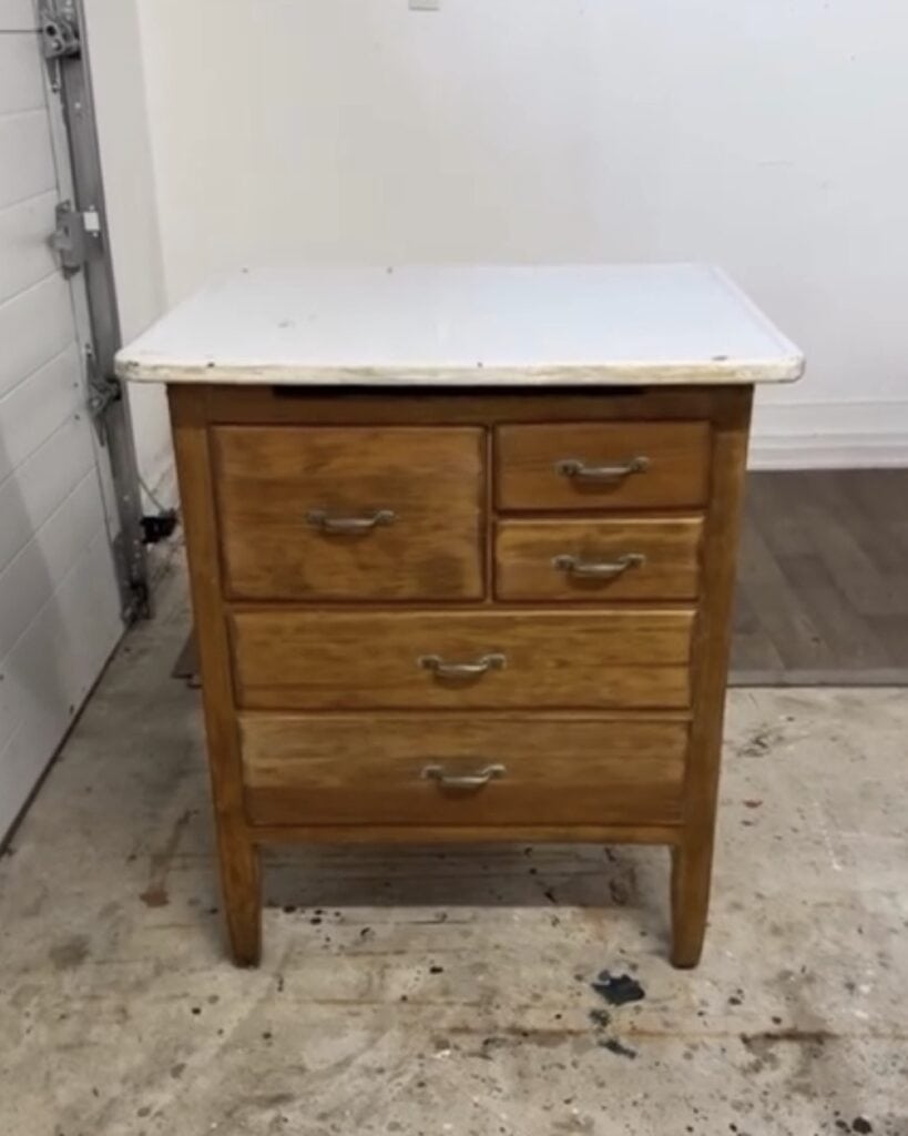 Before photo of rustic wash stand used in this makeover. It has a stained wood base and a metal enameled top.