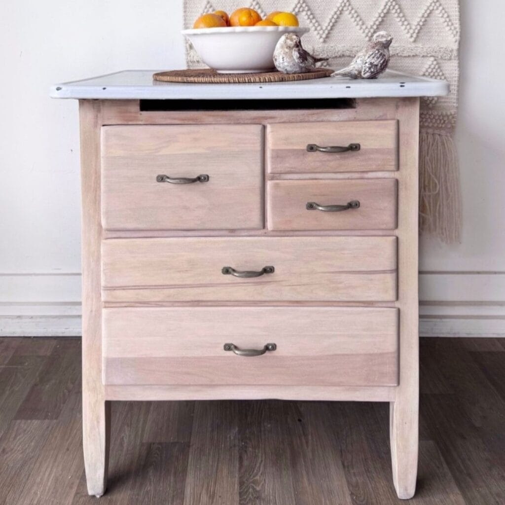 After photo of the wash stand. The wood has been refinished in a natural raw wood finish and the metal enameled top cleaned up.