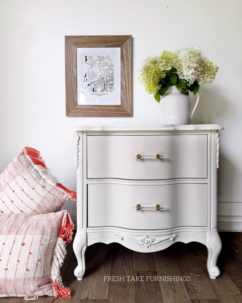 After photo of French provencial nightstand painted off-white with gold and lucite drawer pulls.