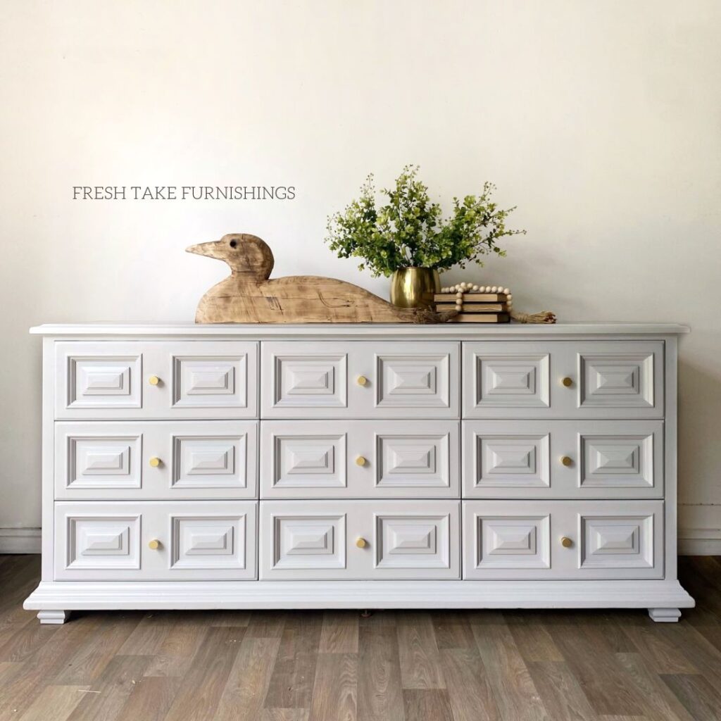 After photo of a Drexel lowboy dresser painted in a light gray with small gold knobs.