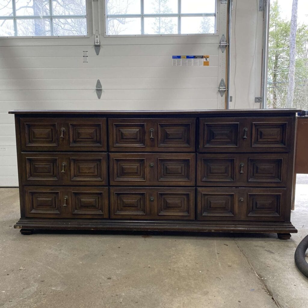 Before photo of a Drexel lowboy dresser with a dark brown stain.