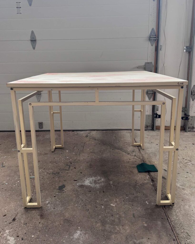 Before photo of white table with metal legs that was used in this Majhong table makeover