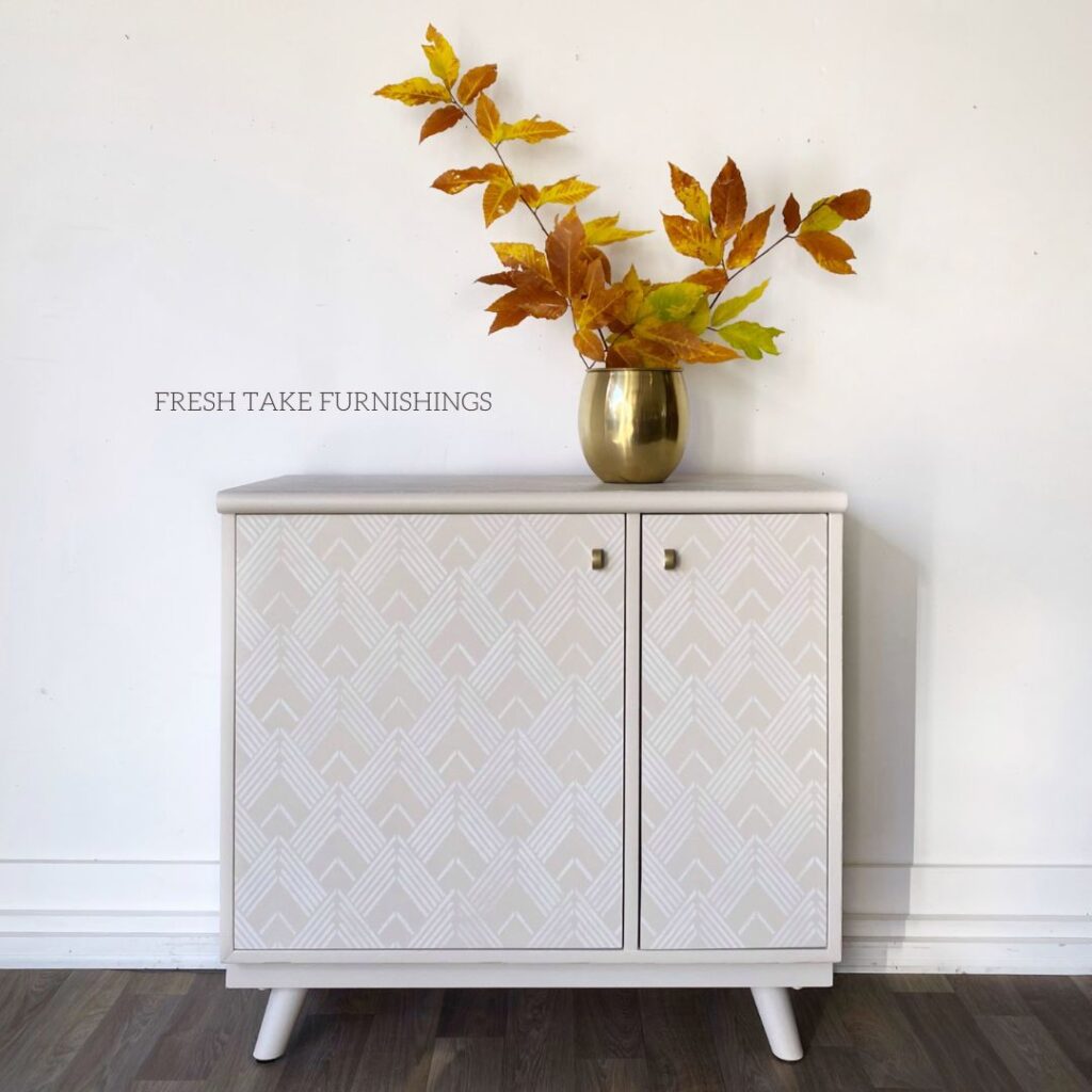 After photo of a wood cabinet that is painted and stenciled.