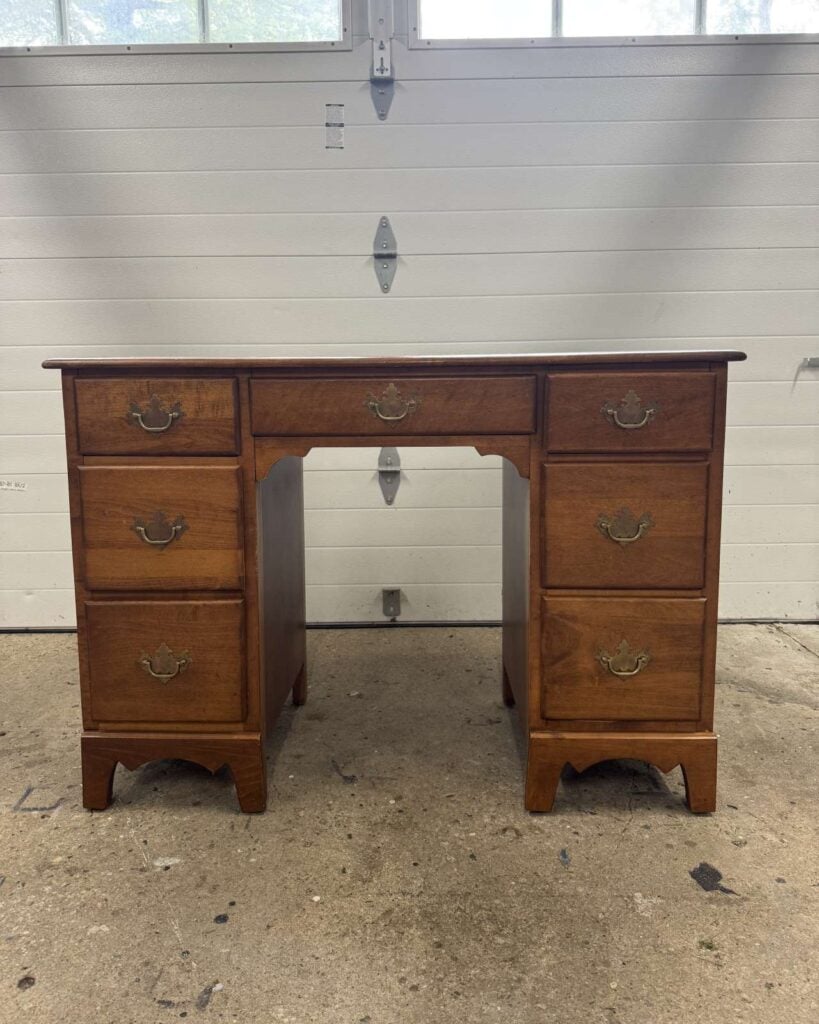 Before photo of stained maple desk.