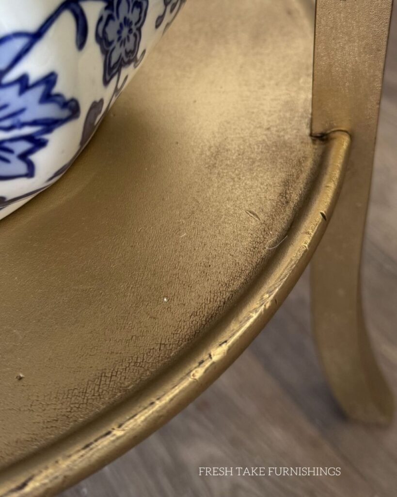 Close up of aged finish on the plant stand.